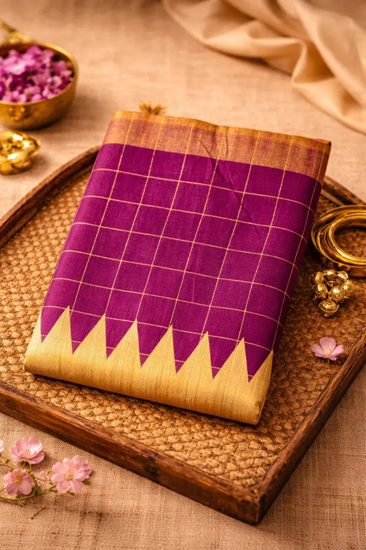 Purple and gold soft silk saree with checkered pattern and zigzag border, displayed on a tray