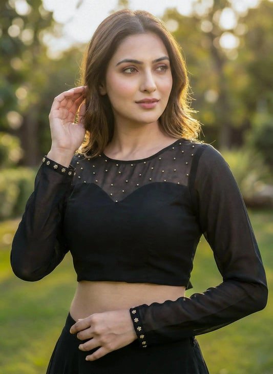 Black SOL BY SMITHA blouse with long sleeves and a relaxed fit, displayed on a hanger.