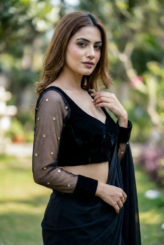 Black net blouse by SOL BY SMITHA featuring sheer fabric and intricate design, displayed on a white background.