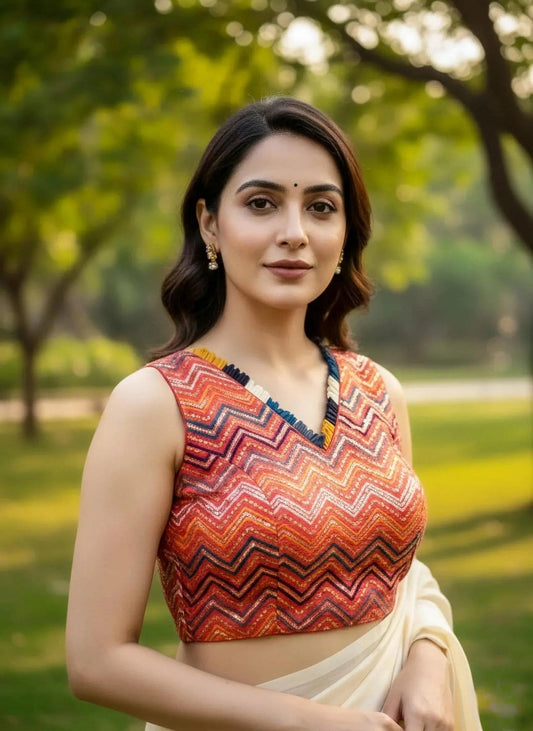 Red sleeveless blouse with intricate embroidery from SOL BY SMITHA, shown on a hanger highlighting the detailed design.