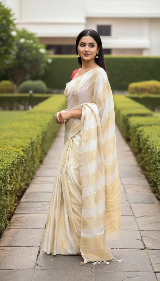 Elegant tissue saree with gold stripe pallu from SOL BY SMITHA, showcasing intricate woven details and luxurious fabric.