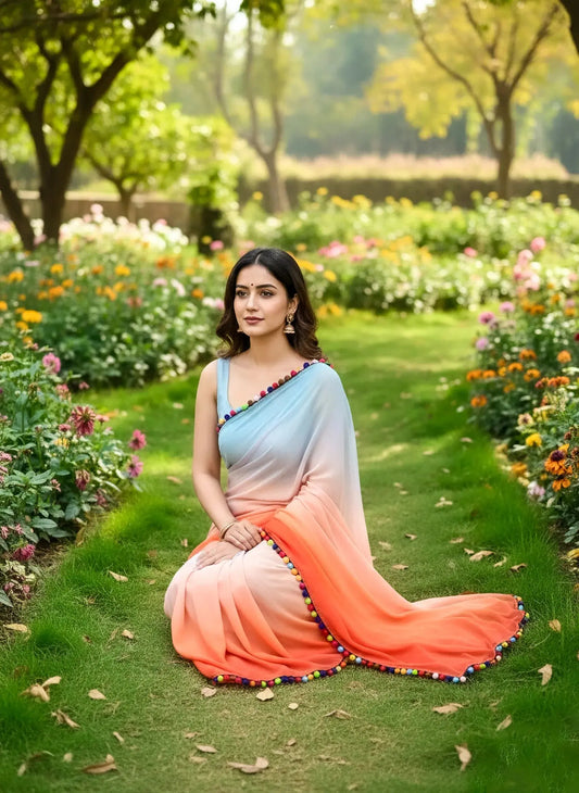 Woman in pastel soft silk saree with colorful border, sitting in a vibrant flower garden