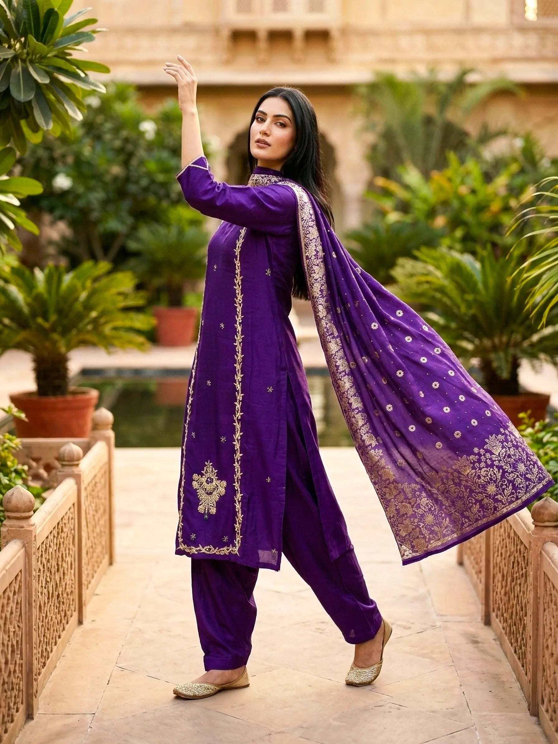 Woman in purple silk salwar kameez with gold embroidery, traditional ethnic wear outdoors