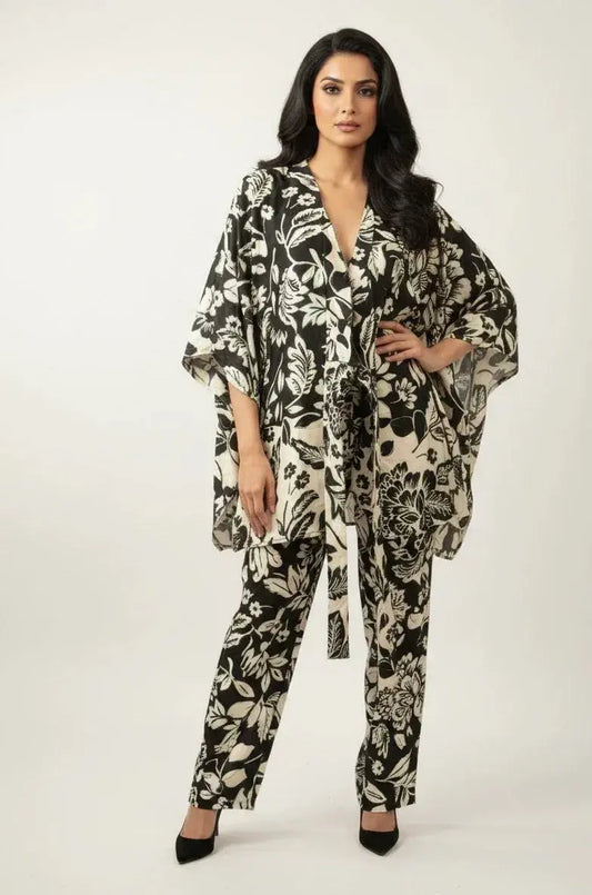 Woman wearing black and white floral print kimono top with matching pants, stylish ethnic wear