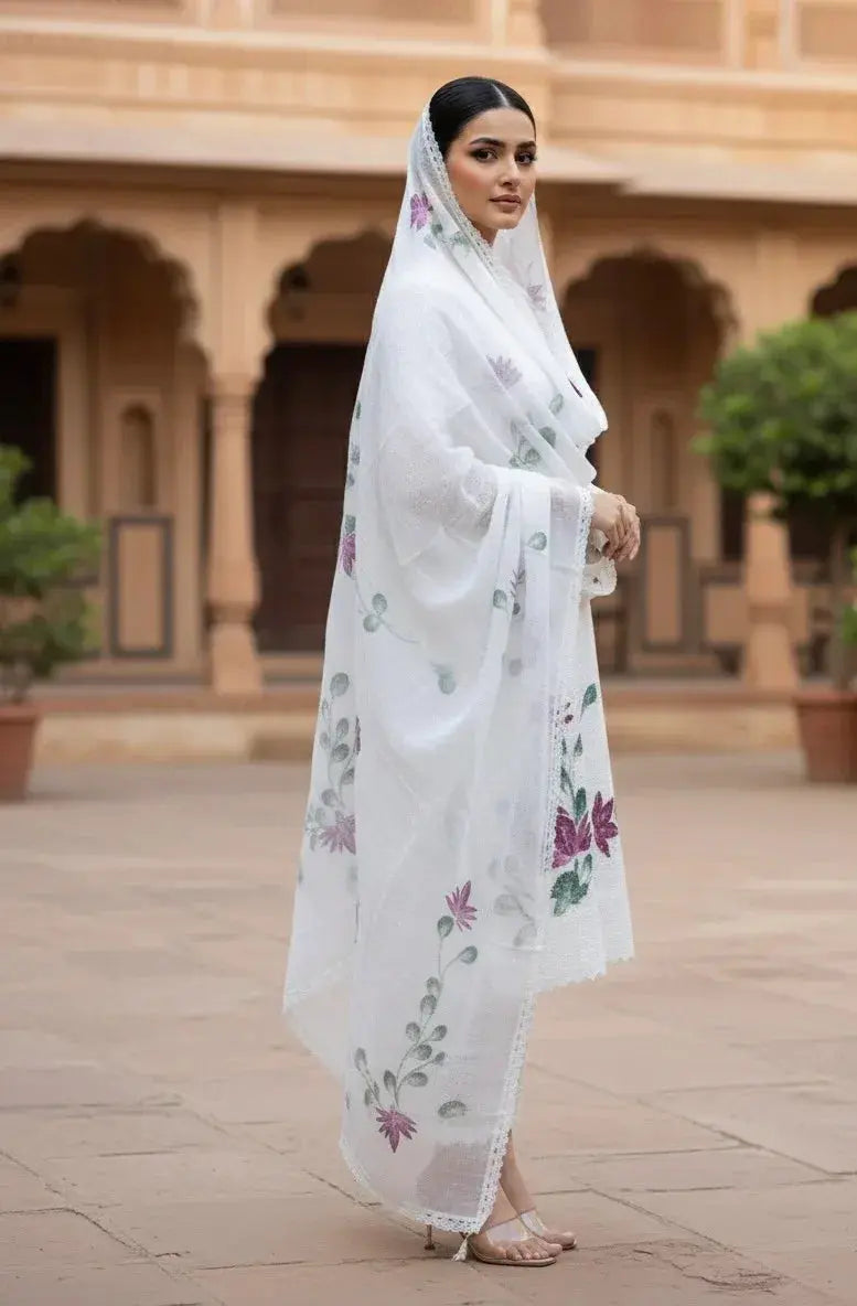 Woman in white soft silk saree with floral embroidery, traditional ethnic wear outdoors