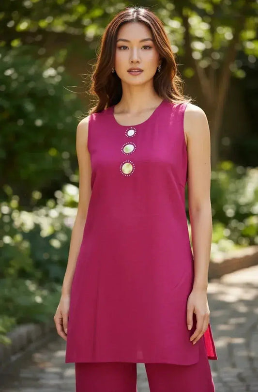 Woman in magenta sleeveless kurta set with statement buttons, outdoor garden background