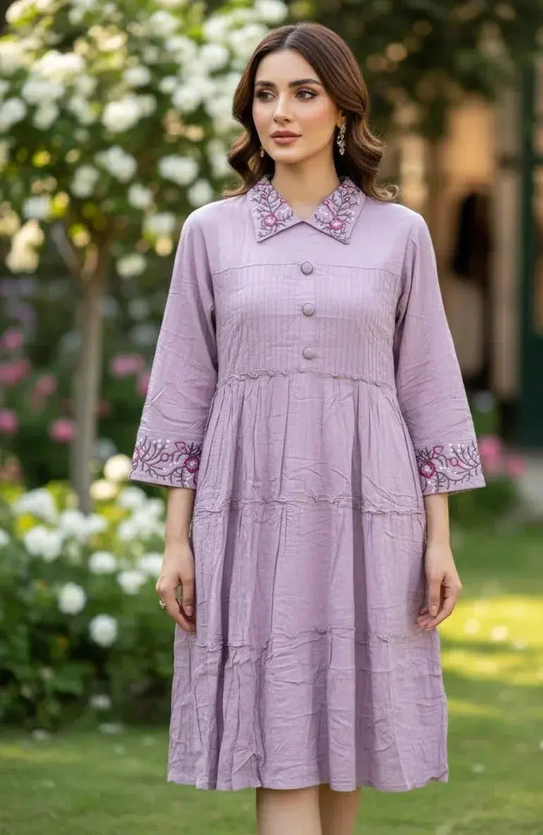 Woman in a lilac embroidered kurta dress with floral collar and three-quarter sleeves, outdoors