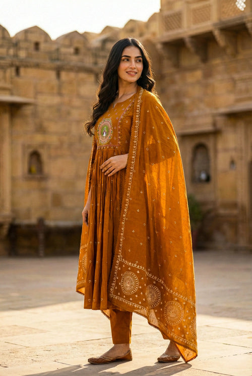 Woman wearing rust embroidered pure cotton 3-piece ethnic suit set with dupatta outdoors