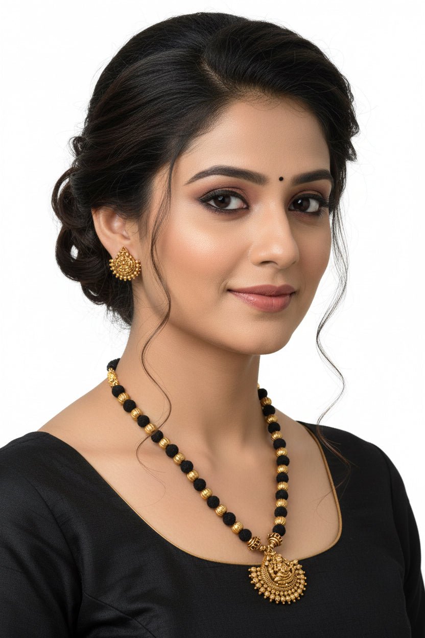 Black Rope Lakshmi pendant by Sol by Smitha, featuring a detailed gold-toned Lakshmi design on black cord.