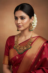 Heavy Lakshmi set earrings by Sol by Smitha with mango green, red, and white drops, featuring intricate traditional design.