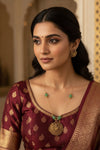 Invisible Nagalakshmi green and red pendant by Sol by Smitha, featuring intricate design and vibrant colors.